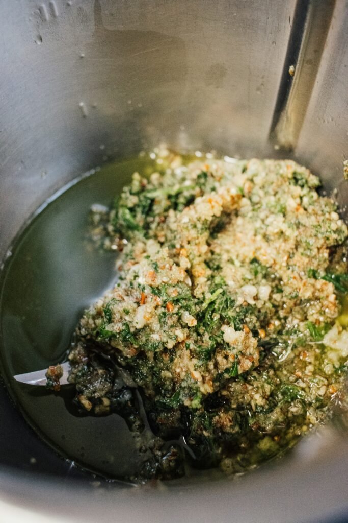 A metal bowl filled with a mixture of food